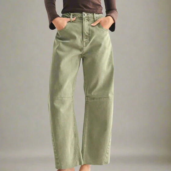 Green pants worn by a person on a gray background