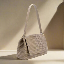  Beige woven handbag on a white background