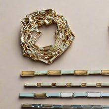  Gold and silver chain links on a wooden surface